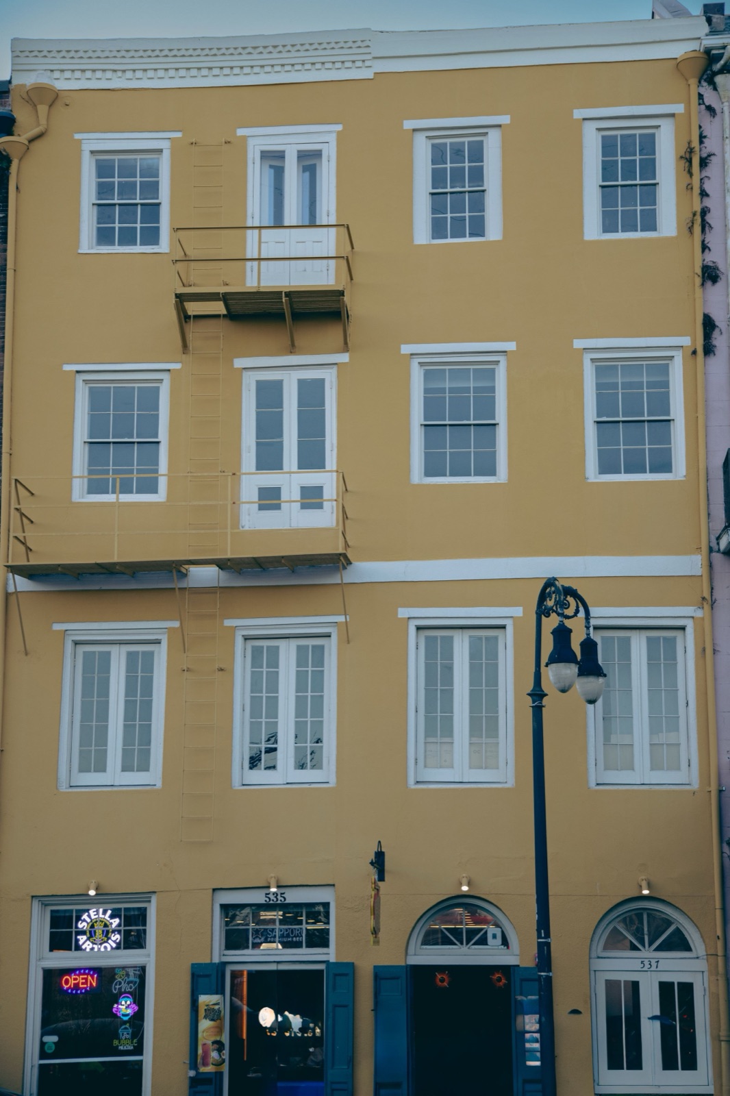A front door with the porch light on