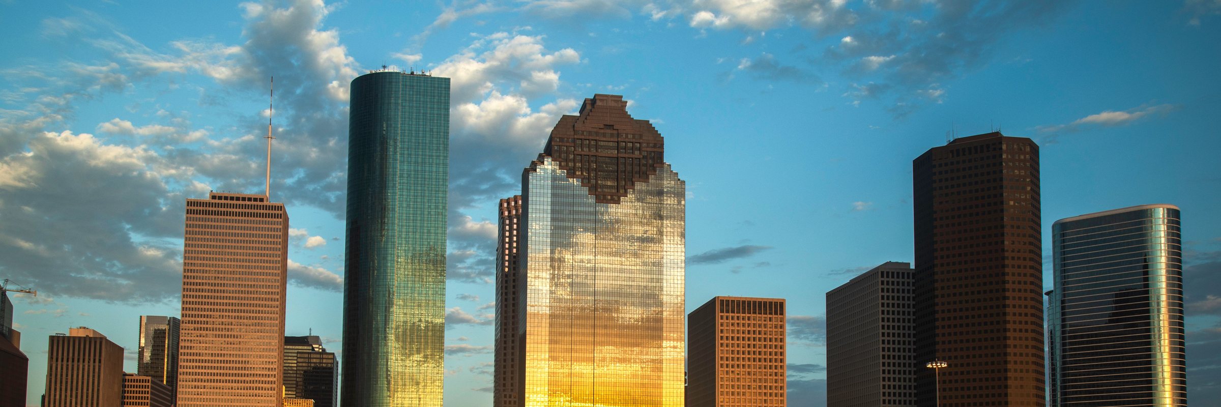 Downtown Houston at sunset, the low sun reflected down the face of a glass tower